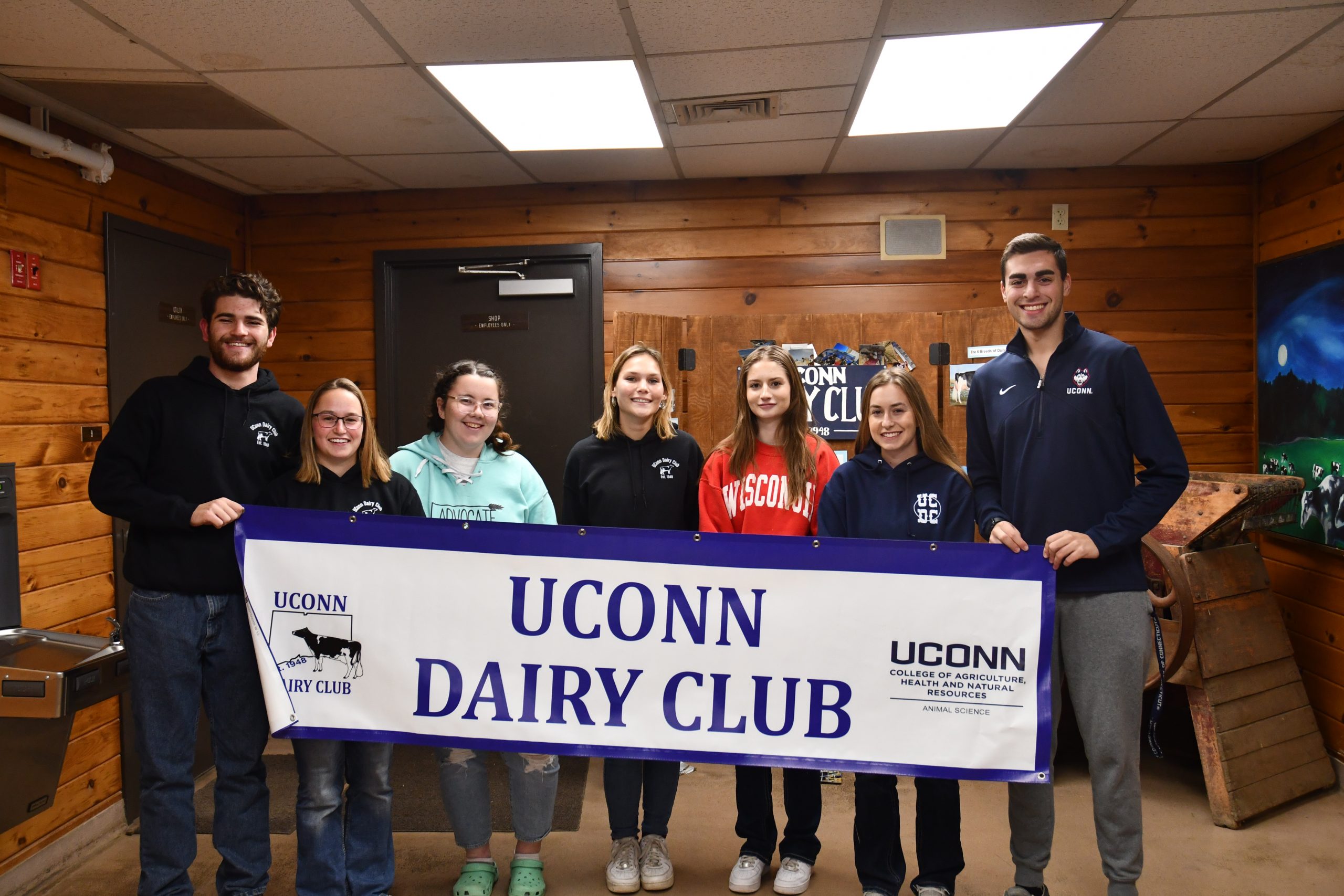 Officer team holding a dairy club banner